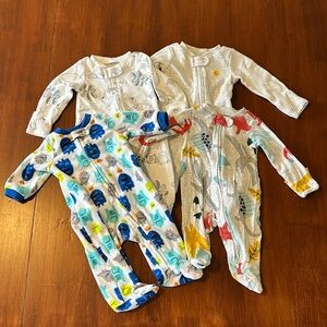 Lot of four newborn footed one-pieces, used